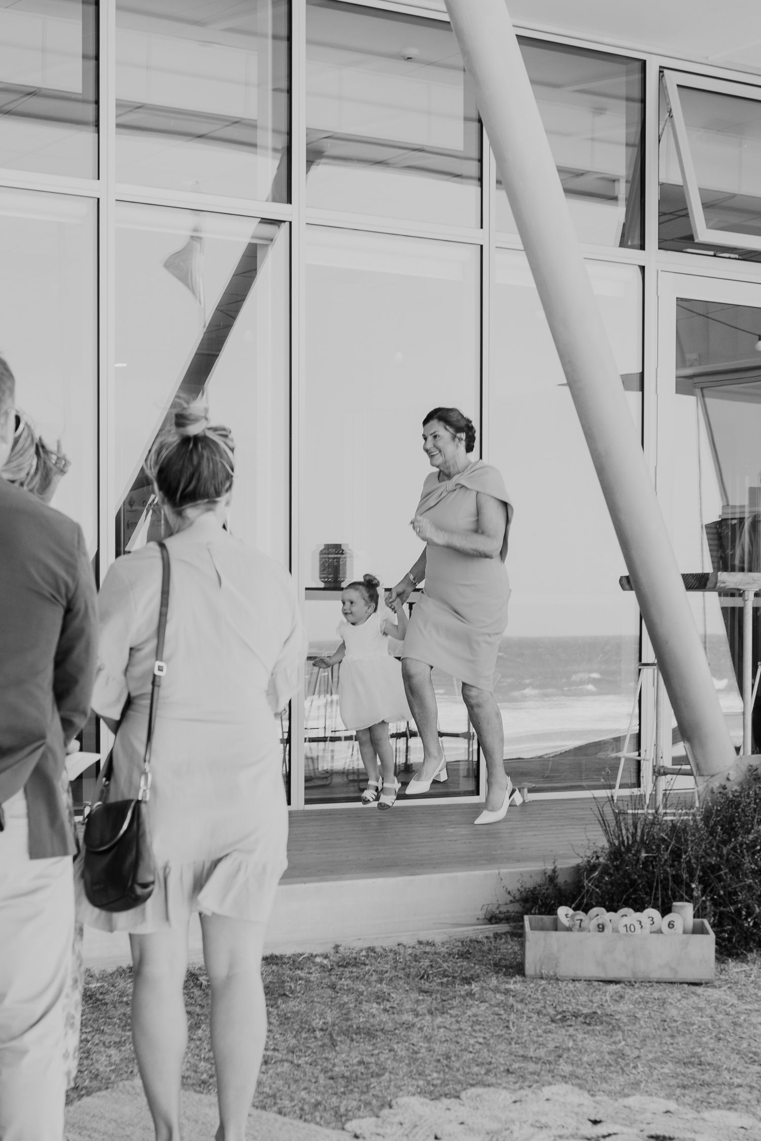 Black and white photo of people washing windows on the exterior of a building.