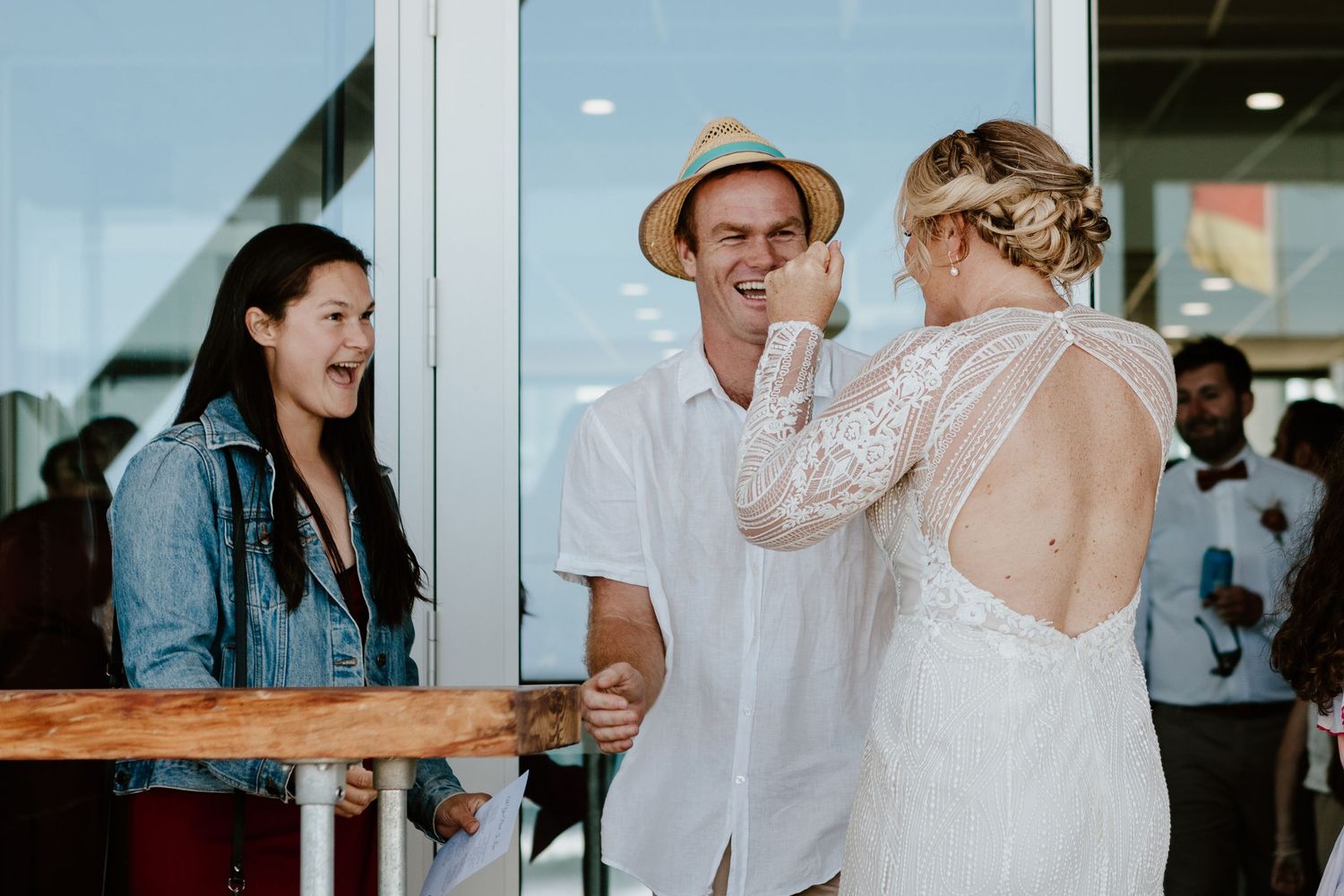 Wedding celebration featuring candid hugs and interactions between guests.
Papamoa Beach Wedding