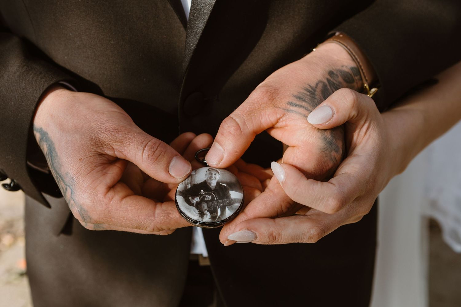 A person adjusts their black bowtie and formal attire while getting dressed.