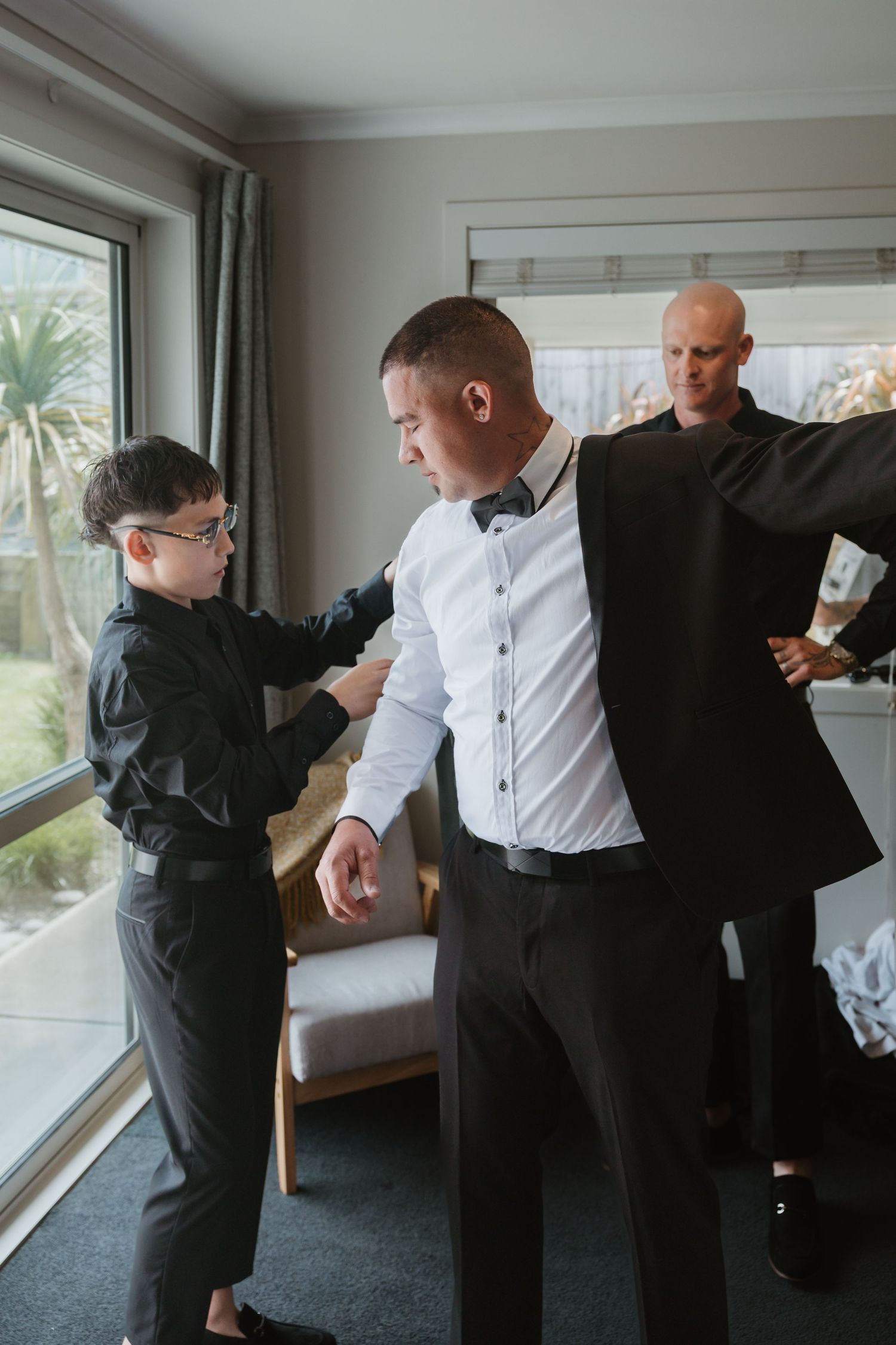 A sequence of photos showing people getting dressed in formal attire with white shirts and black suits.