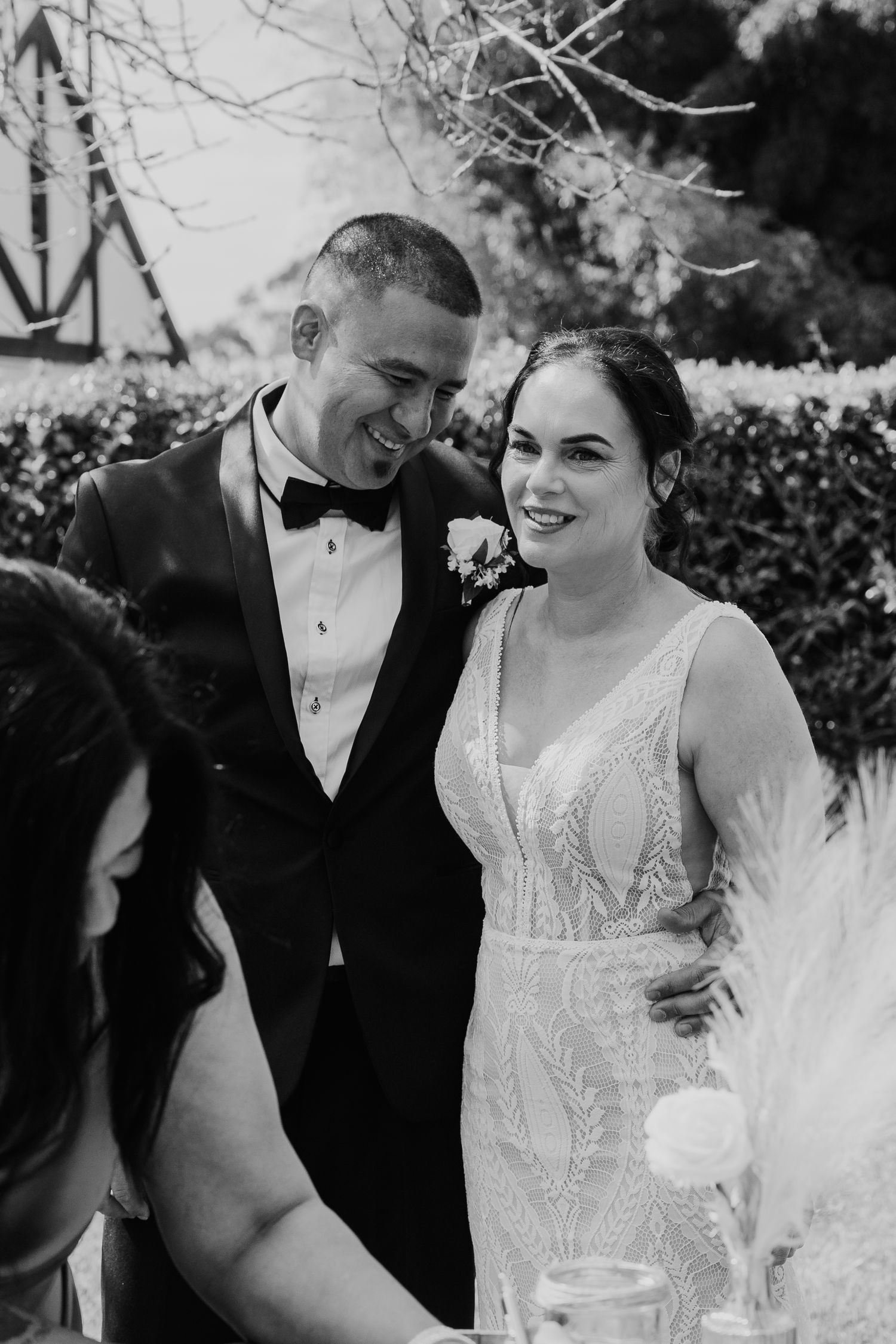 A happy couple shares joyful moments in black and white wedding photos showing genuine laughter and connection.