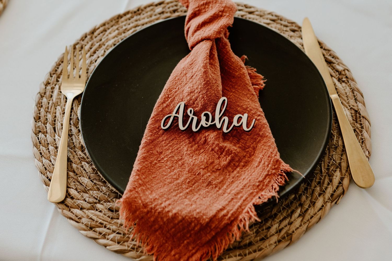 Rustic woven baskets with coral-colored cloth decor arranged for wedding celebration. Papamoa Surf Lifesaving Club Wedding