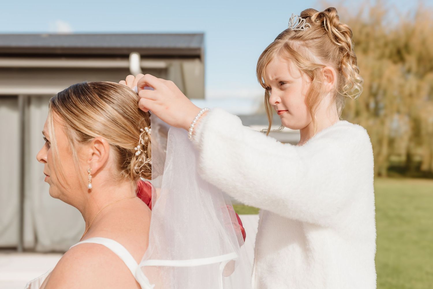 A series of wedding photography shots showing the bride getting ready with hair and makeup preparations outdoors.