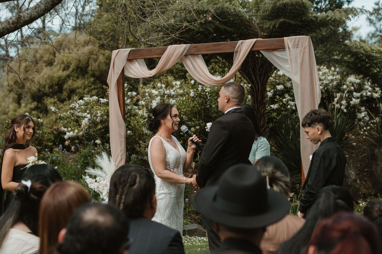 A series of romantic wedding moments captured at an outdoor ceremony with draped fabric decor and natural scenery.