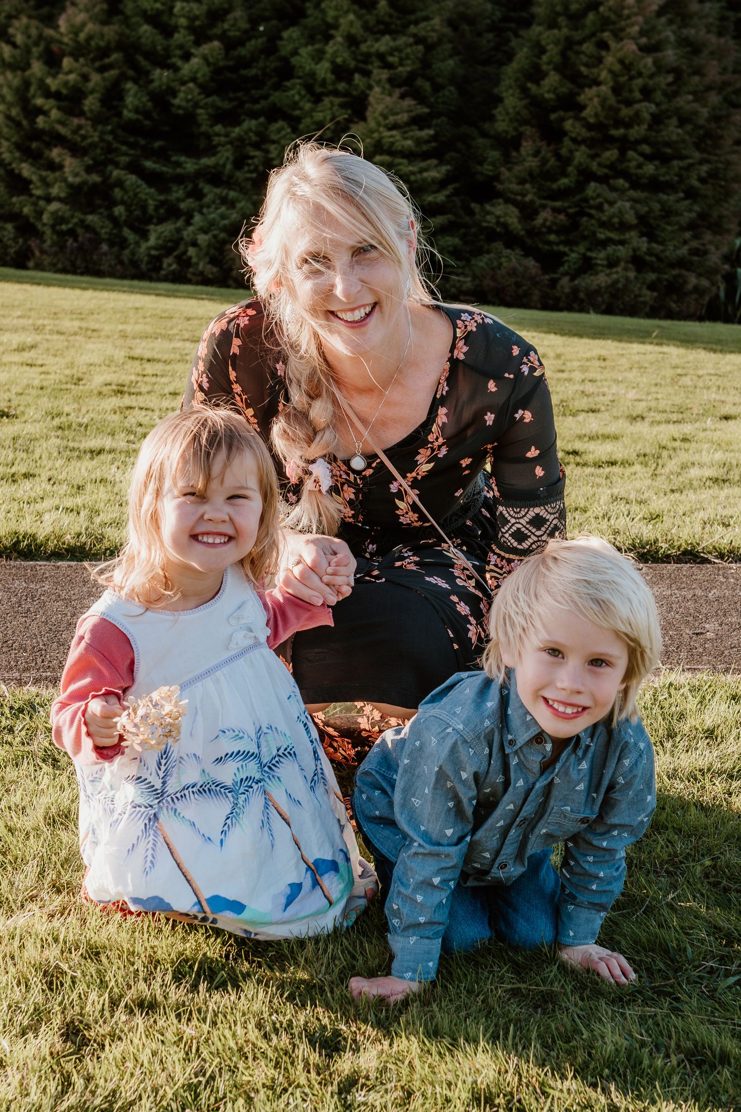 Three outdoor lifestyle photos show joyful family moments on a sunny lawn with evergreen trees in the background.