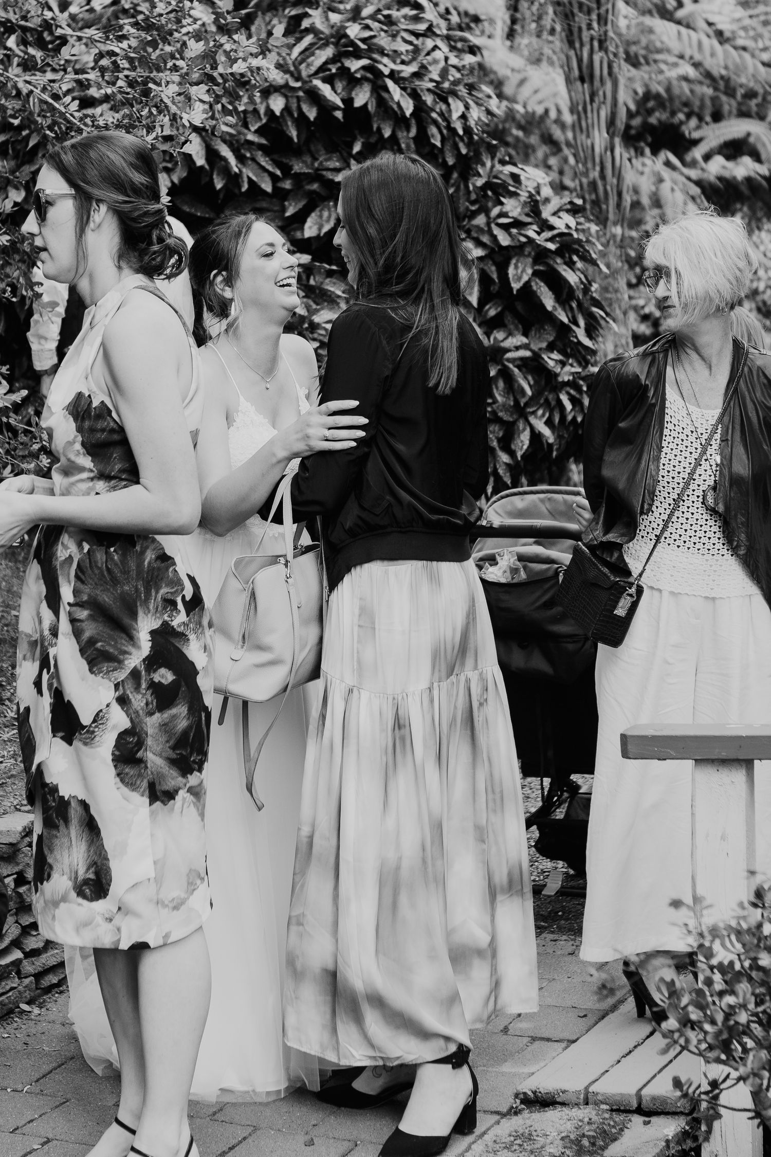 A series of black and white photos showing people in white dresses enjoying festivities in an outdoor garden setting.