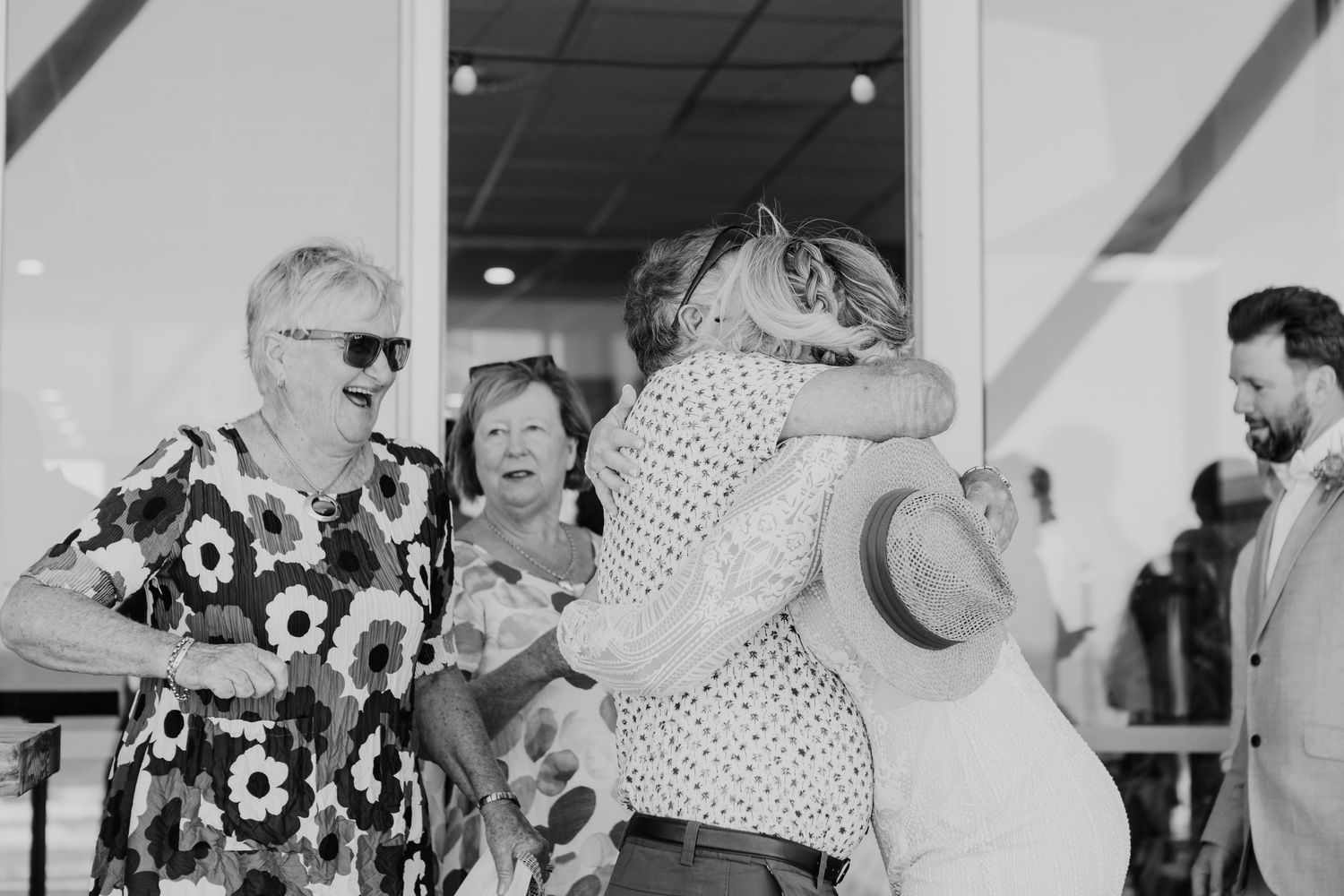 A collection of black and white wedding reception photos showing dancing guests and candid celebration moments.