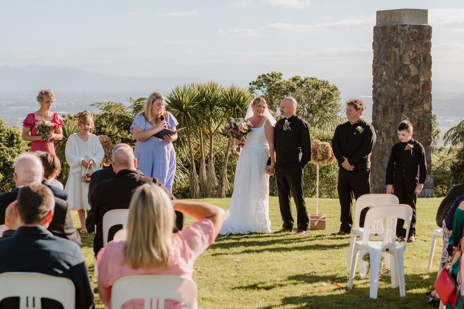 A series of six side-by-side photos showing an outdoor wedding ceremony with guests gathered in a scenic natural setting.