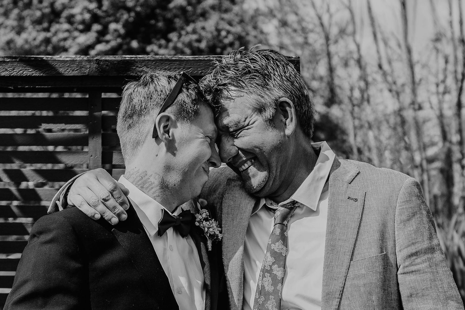 Black and white wedding photo sequence showing couple sharing intimate moments outdoors.