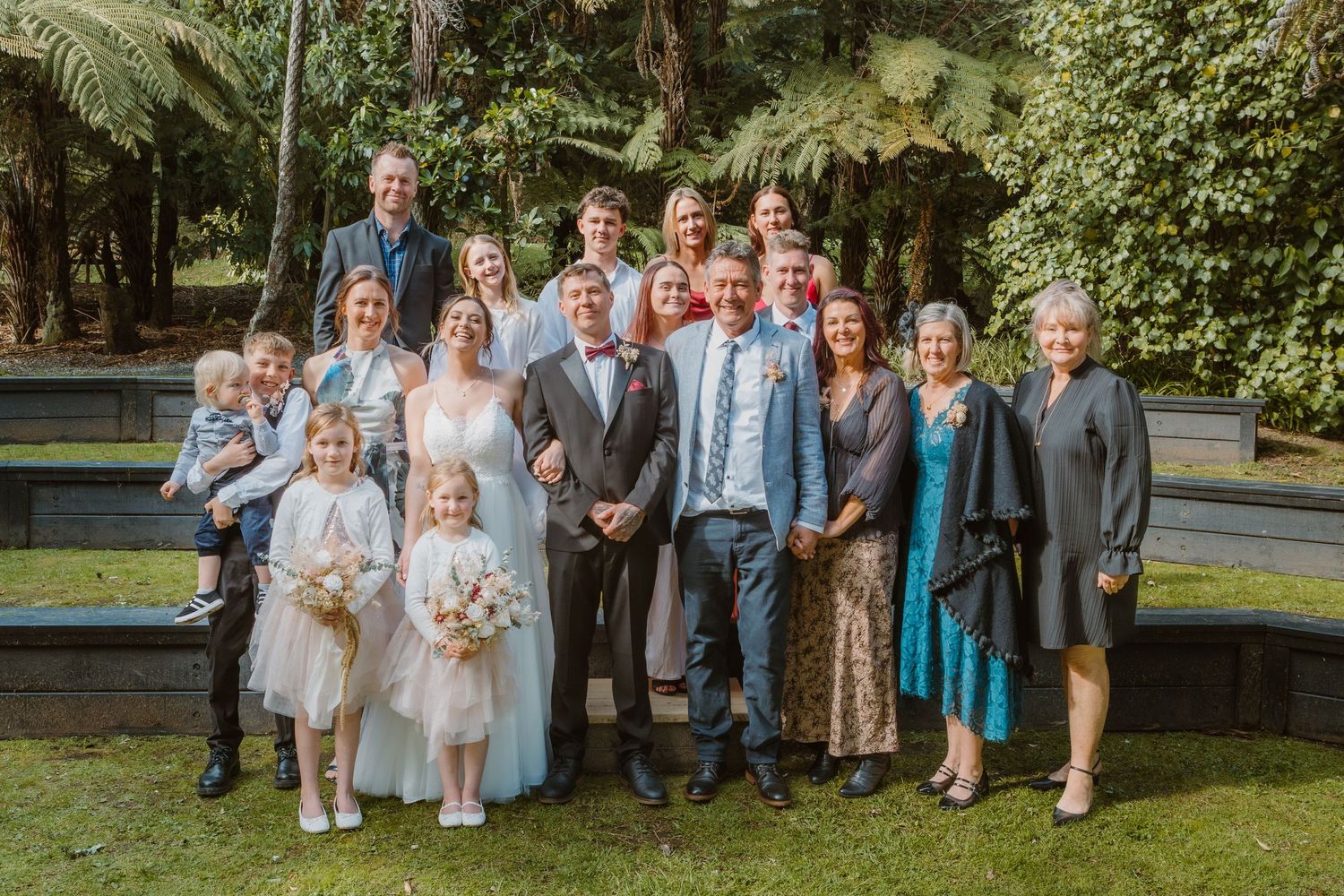 Intimate family wedding photo with group gathered on outdoor steps.