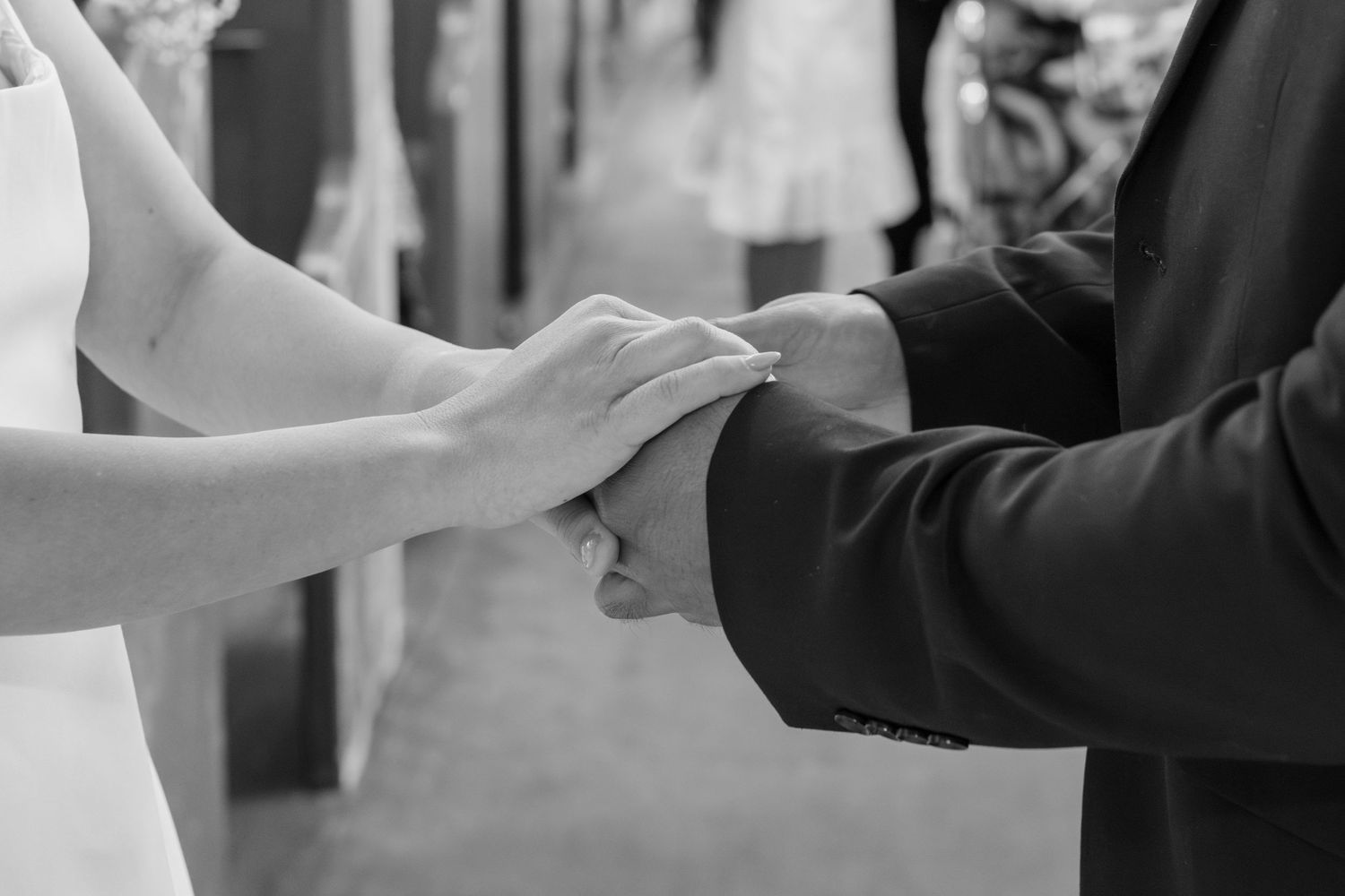 Intimate close-up of wedding ring exchange between couple during ceremony.
