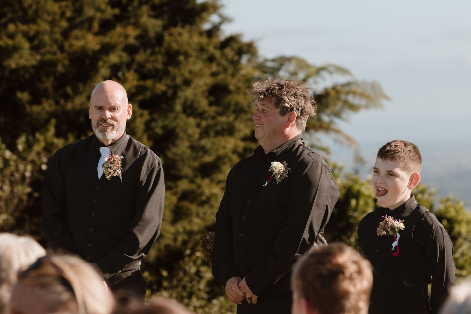 Laughter and joyful moments shared at an outdoor ceremony surrounded by natural scenery at sunset.