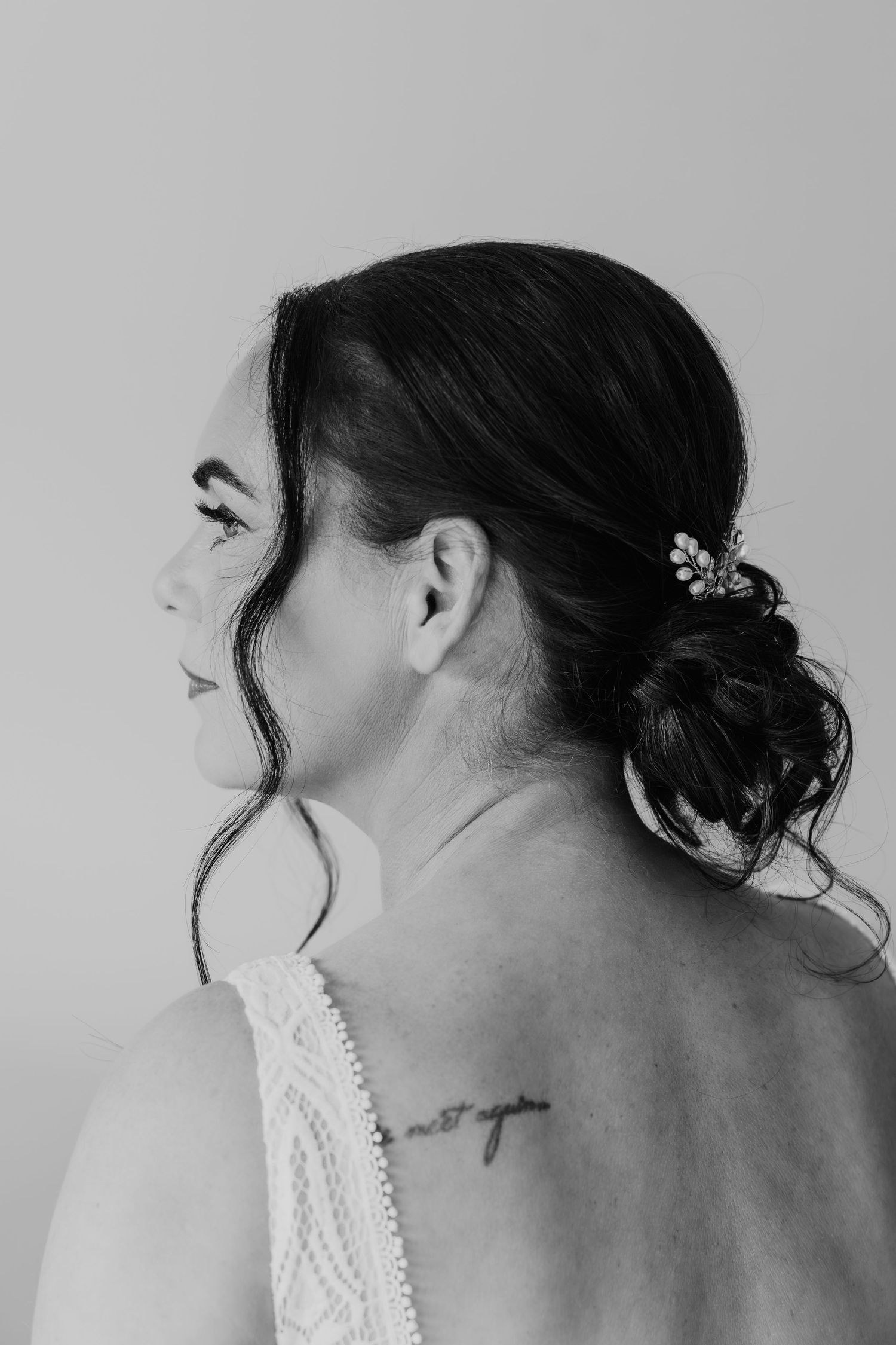 A series of black and white profile portraits showing an elegant updo hairstyle with loose tendrils framing the face.