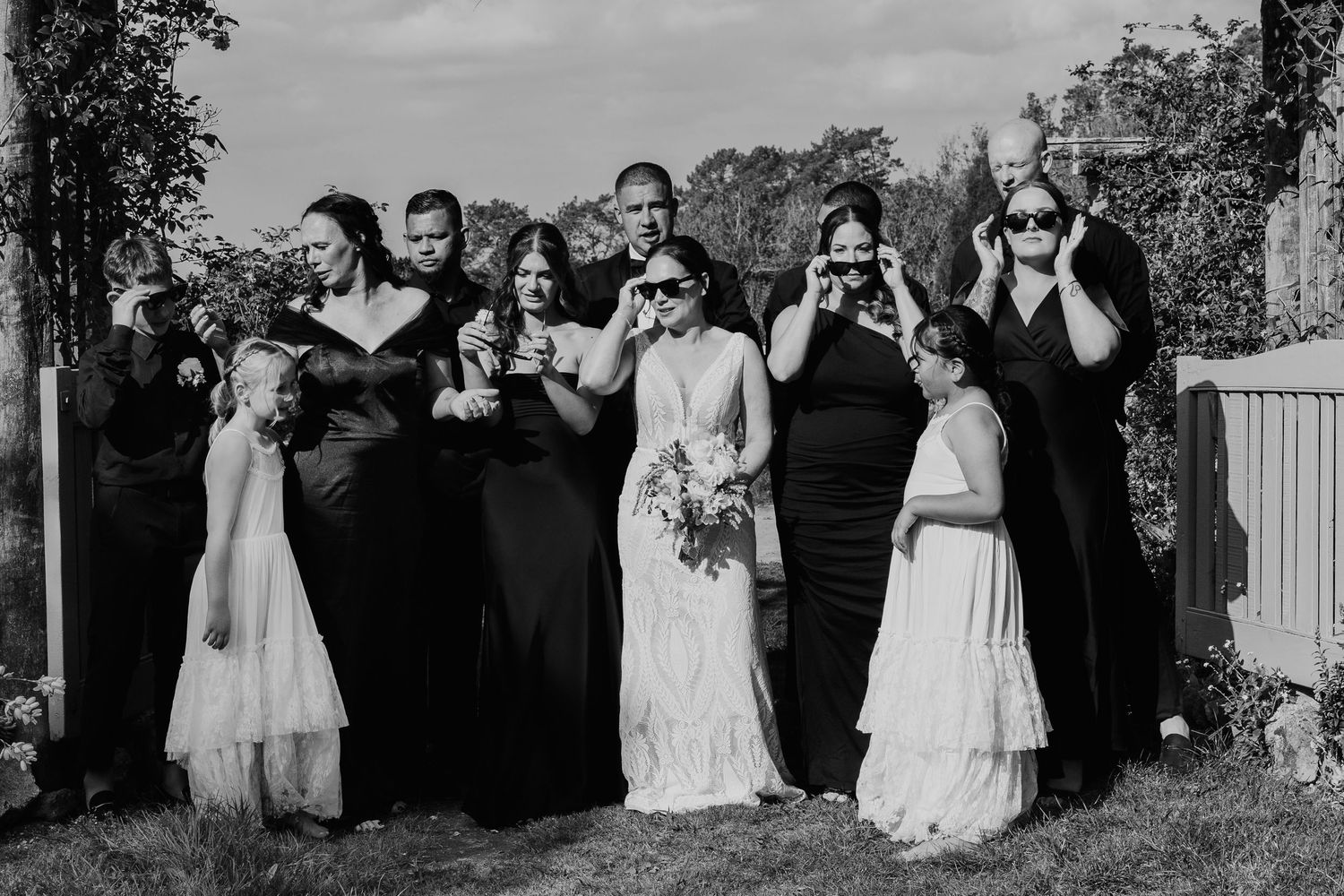 A panoramic sequence of wedding party members reacting emotionally during an outdoor ceremony.