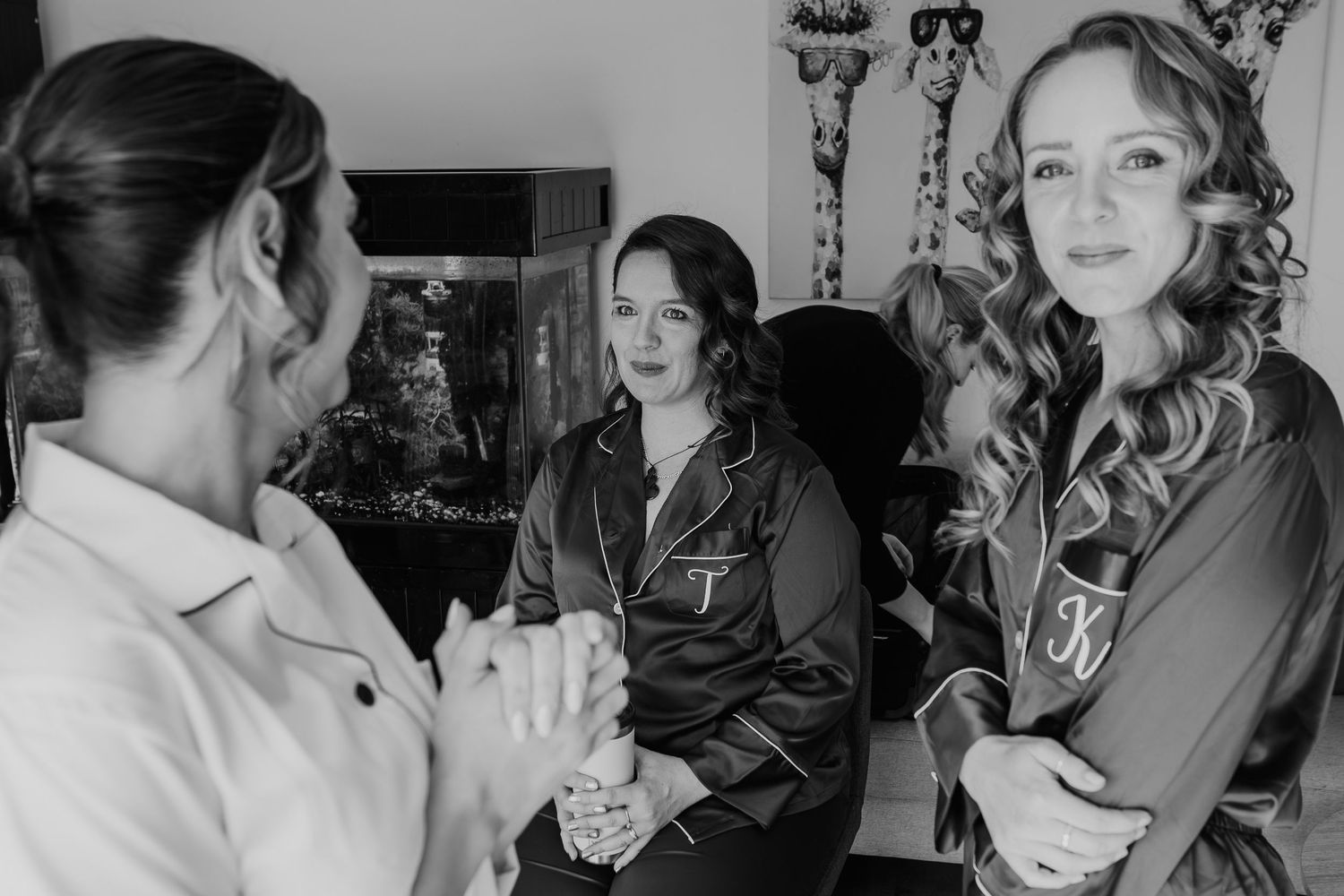 A black and white photo series showing wedding day preparations with people getting ready in a dressing room.