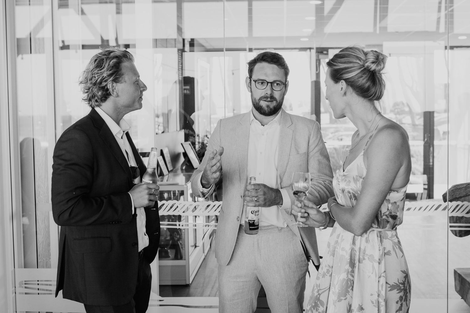 Wedding party mingling and having drinks during a beachside reception. Papamoa Surf Lifesaving Club Wedding