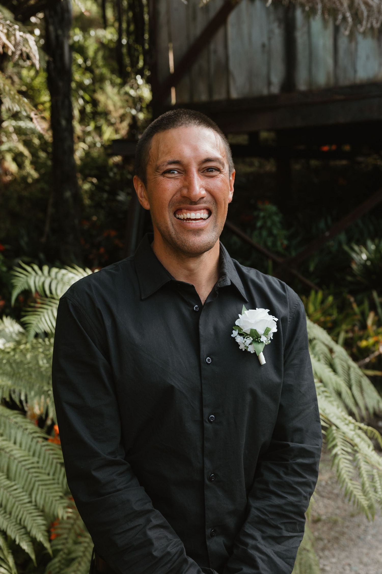 A series of candid portraits showing someone in a black button-down shirt against a natural backdrop with ferns.