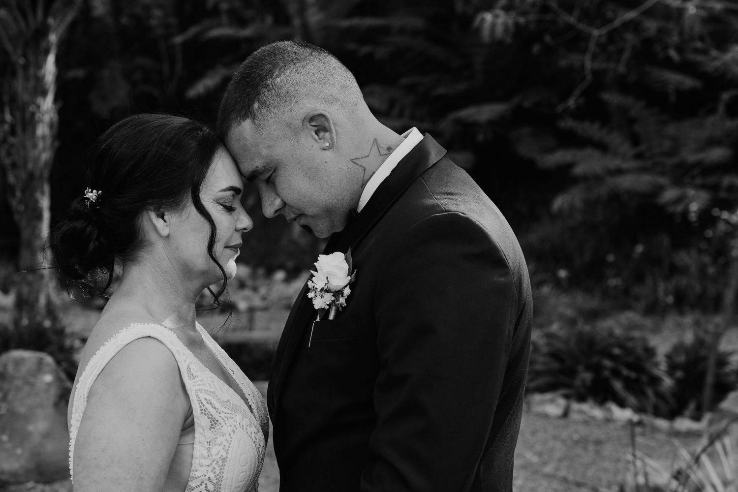A series of romantic black and white wedding photos showing intimate moments between newlyweds in an outdoor setting.