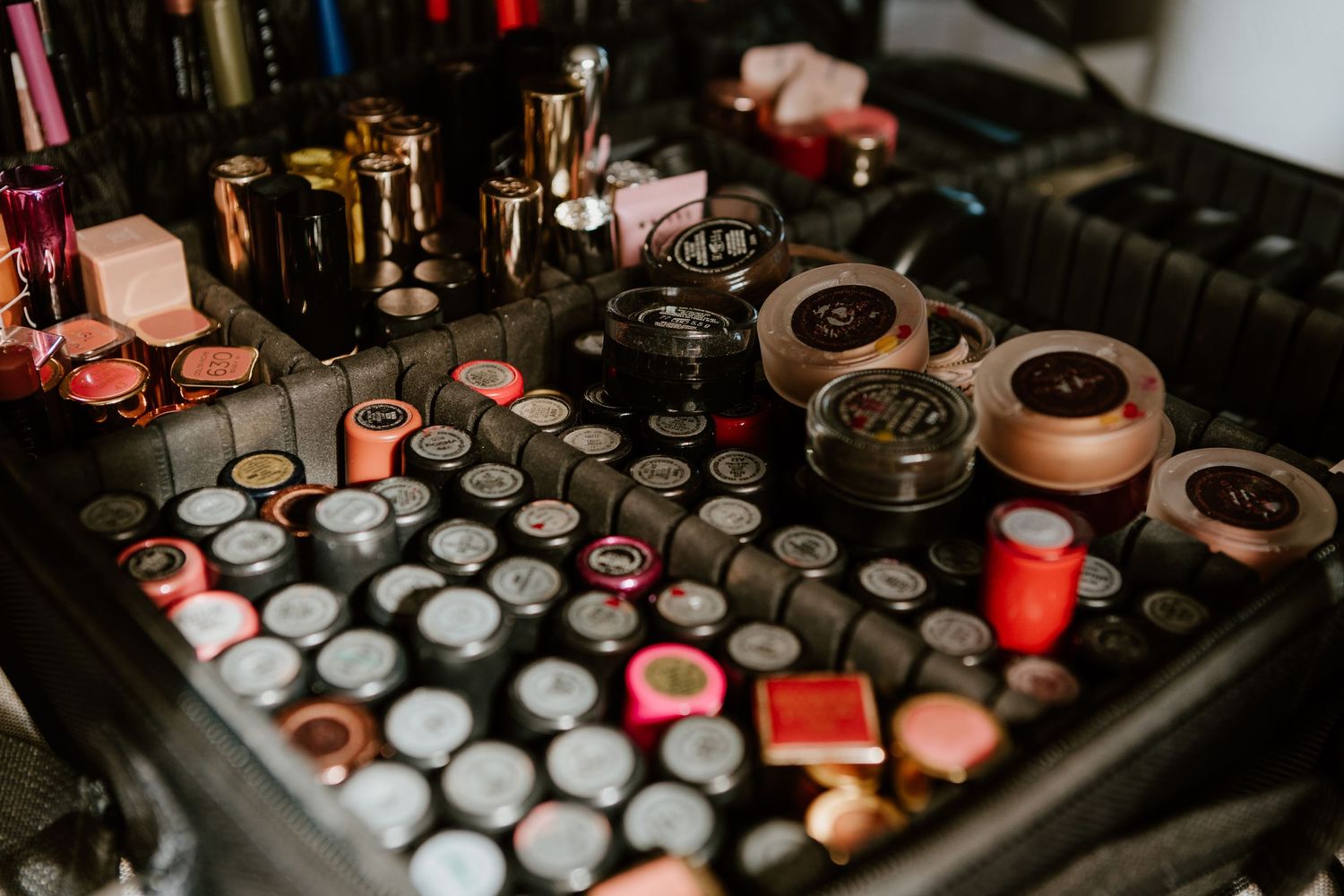 Close-up view of a professional makeup vanity with organized cosmetic products and lipsticks in various shades.