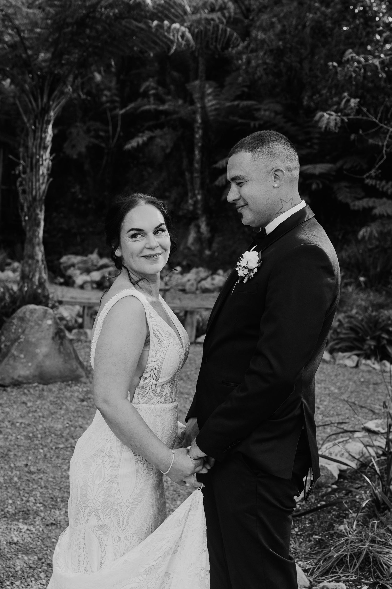 A bride and groom share intimate moments in a garden setting captured in a series of black and white wedding photos.