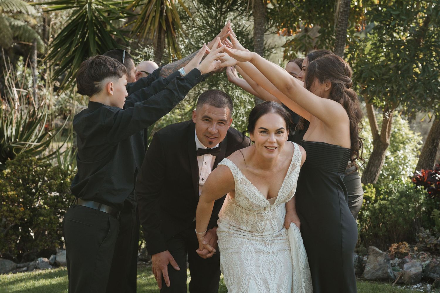 A couple dances together during an outdoor wedding celebration surrounded by trees and natural scenery.