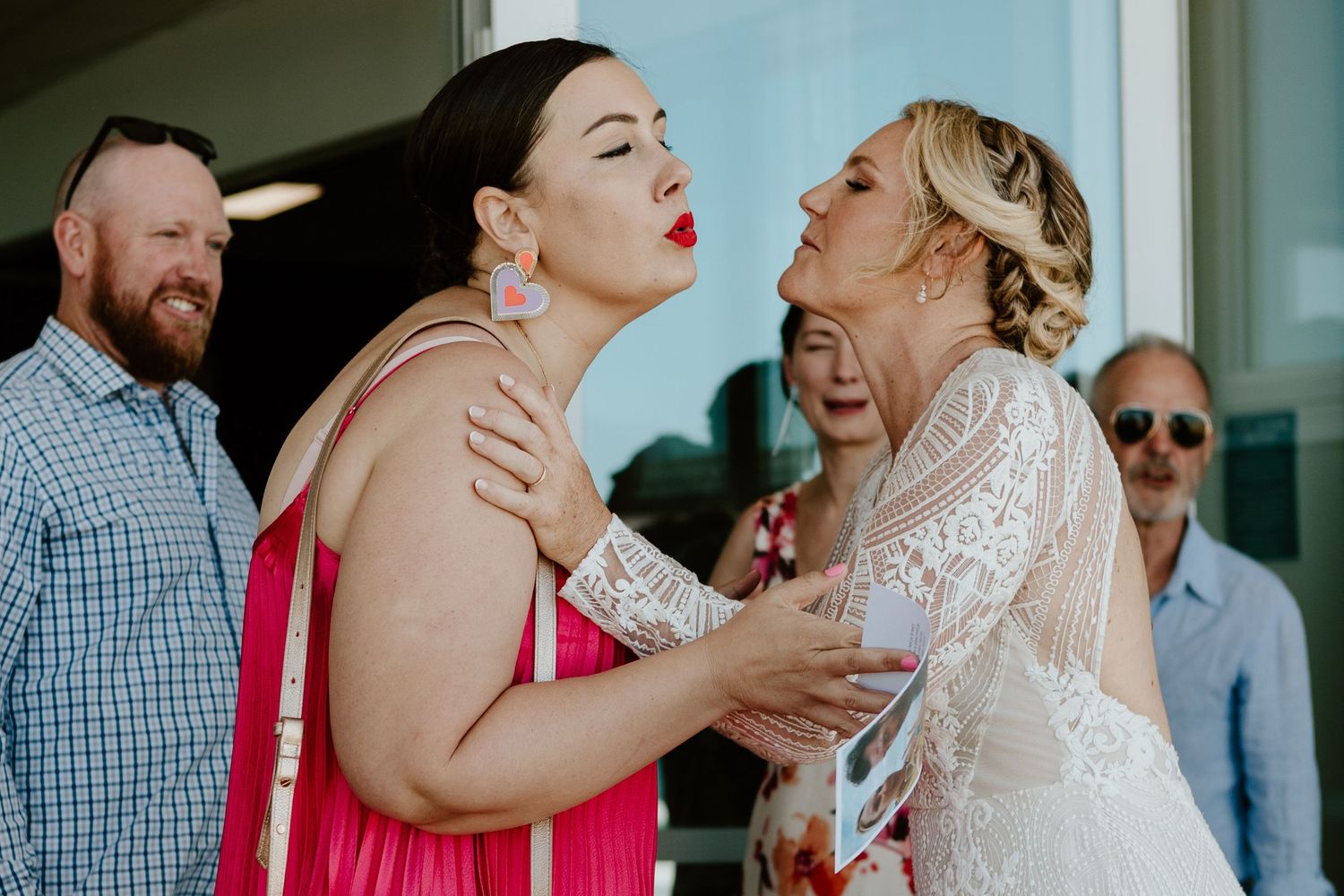 Wedding reception gathering with guests sharing emotional embraces.
Papamoa Beach Wedding