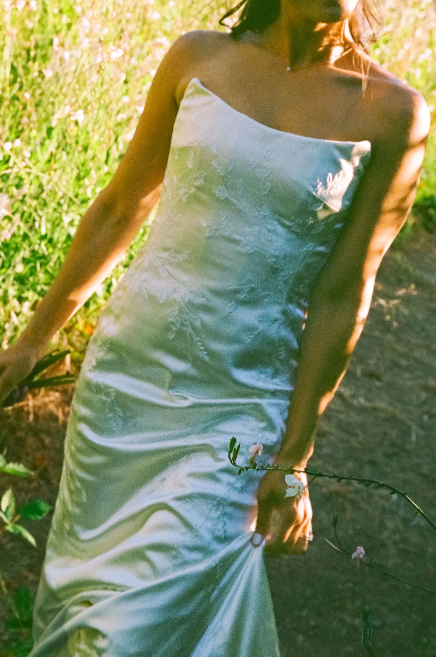 Wedding photos San Diego featuring a wedding guest in a blue satin dress captured in warm natural light