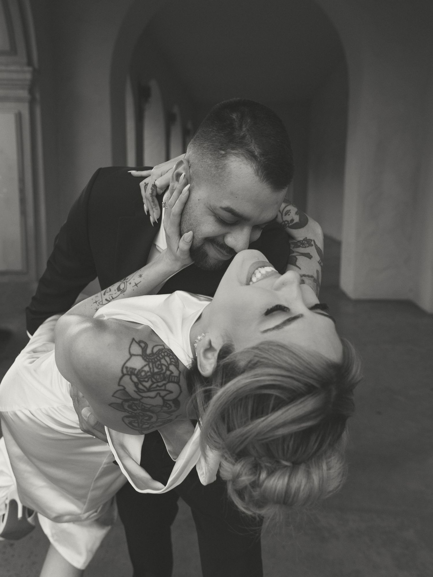 Black and white photo of a couple in formal wear sharing an intimate dance pose.