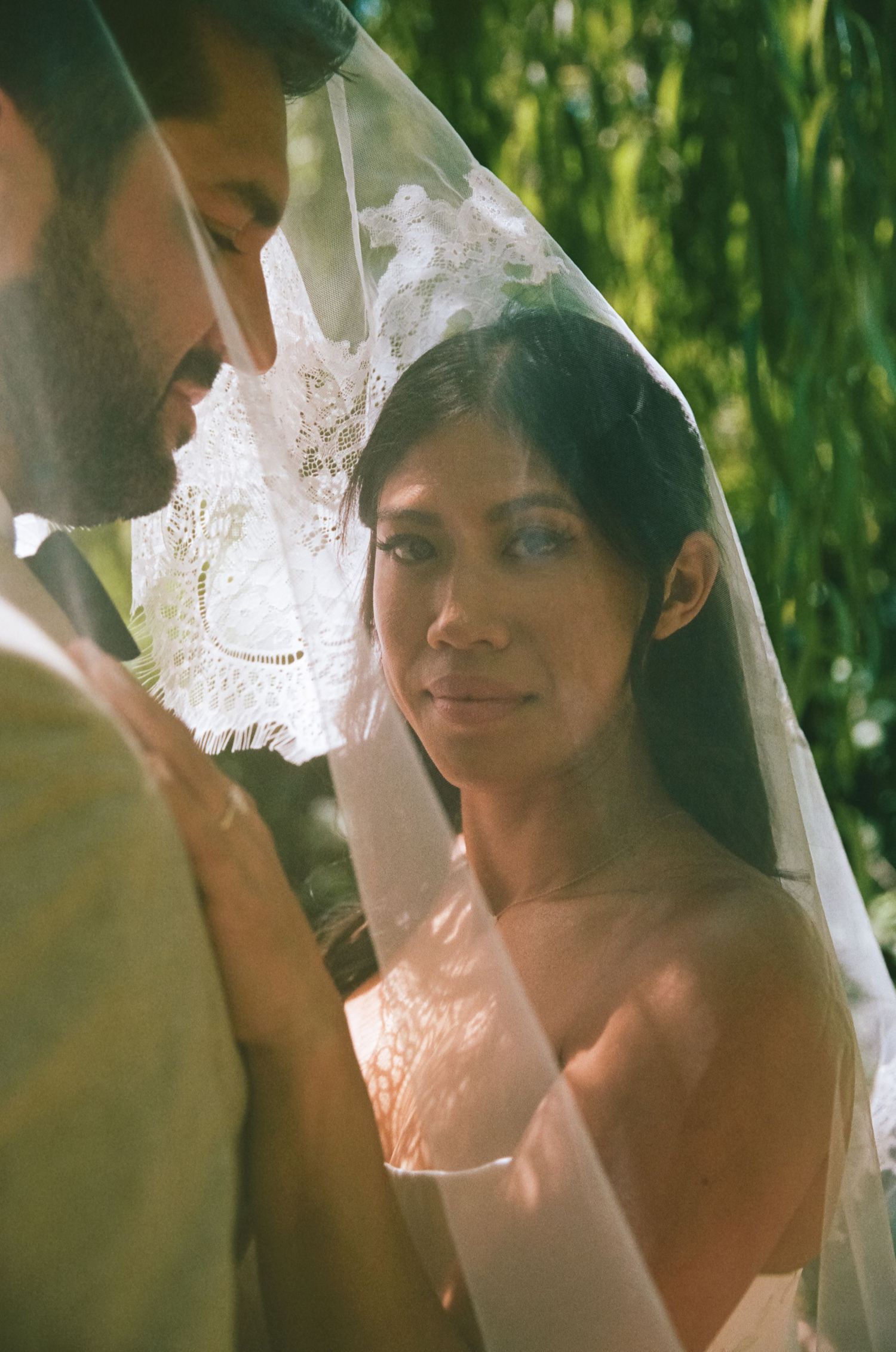 Film wedding photography San Diego capturing a romantic bride beneath her veil in soft natural light