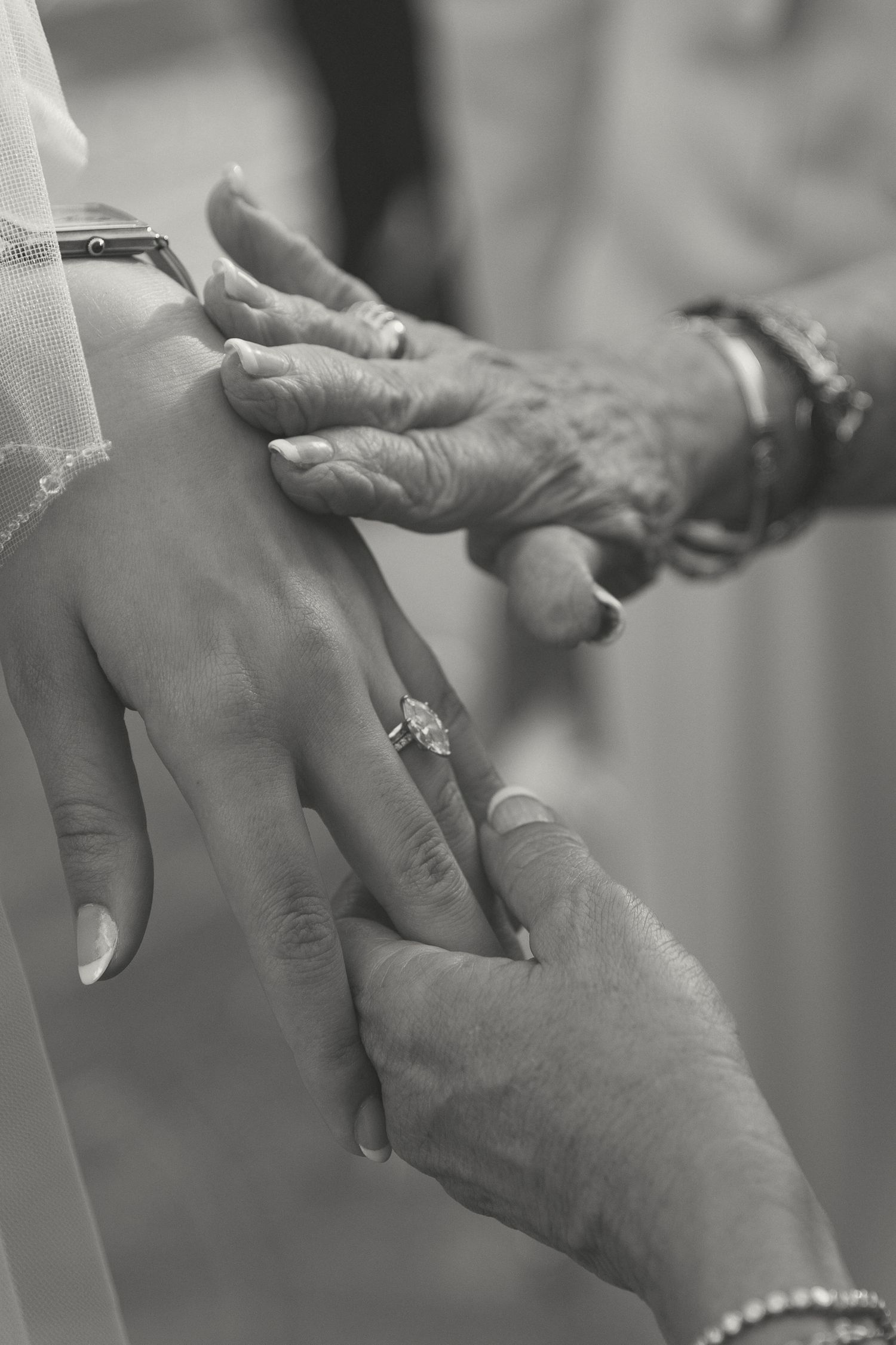 Close up of hands exchanging wedding rings during ceremony.