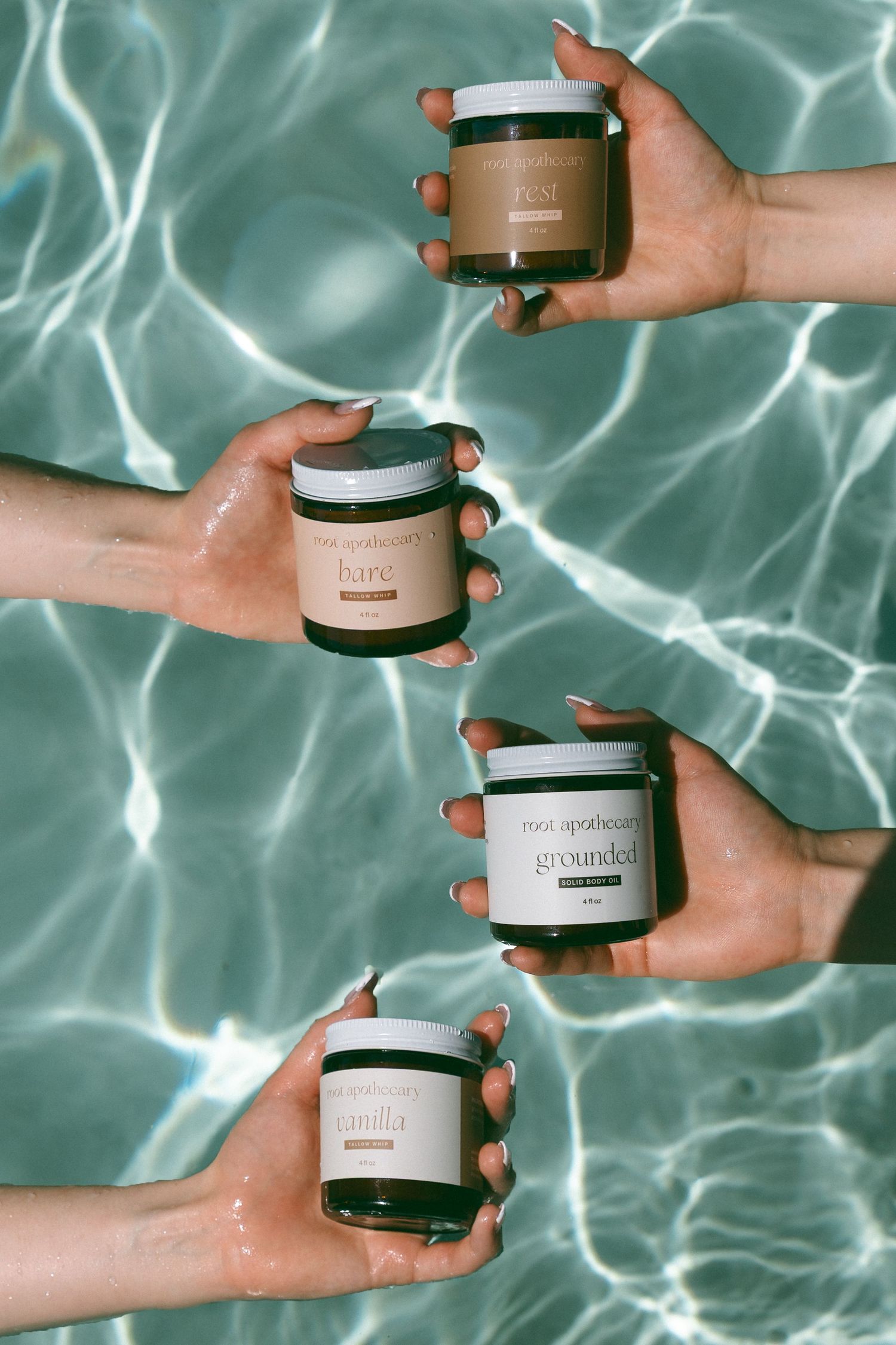 Beauty product jars displayed against rippling turquoise water background showing skincare collection.