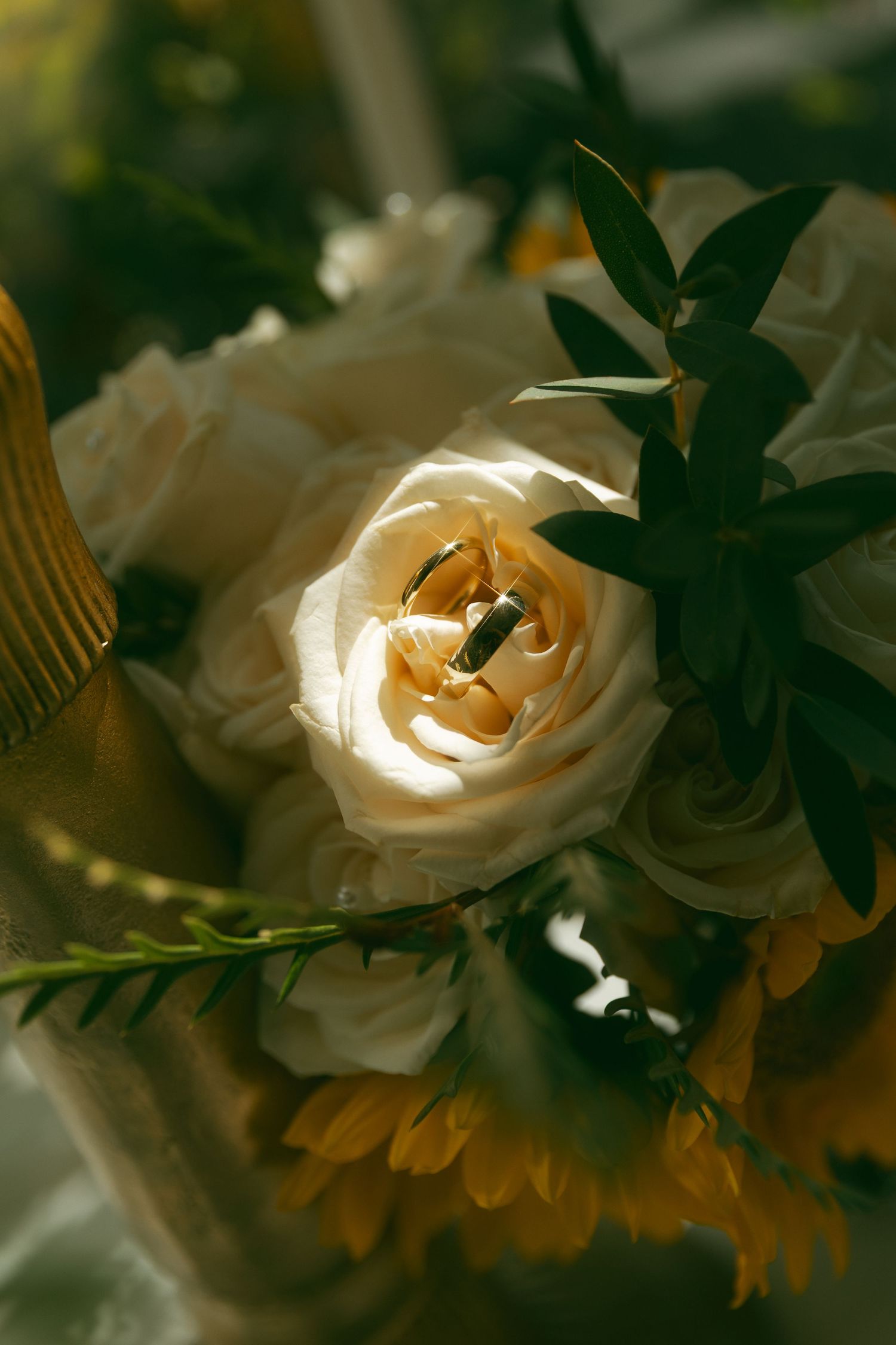 Delicate white roses in soft focus create a romantic wedding floral arrangement.