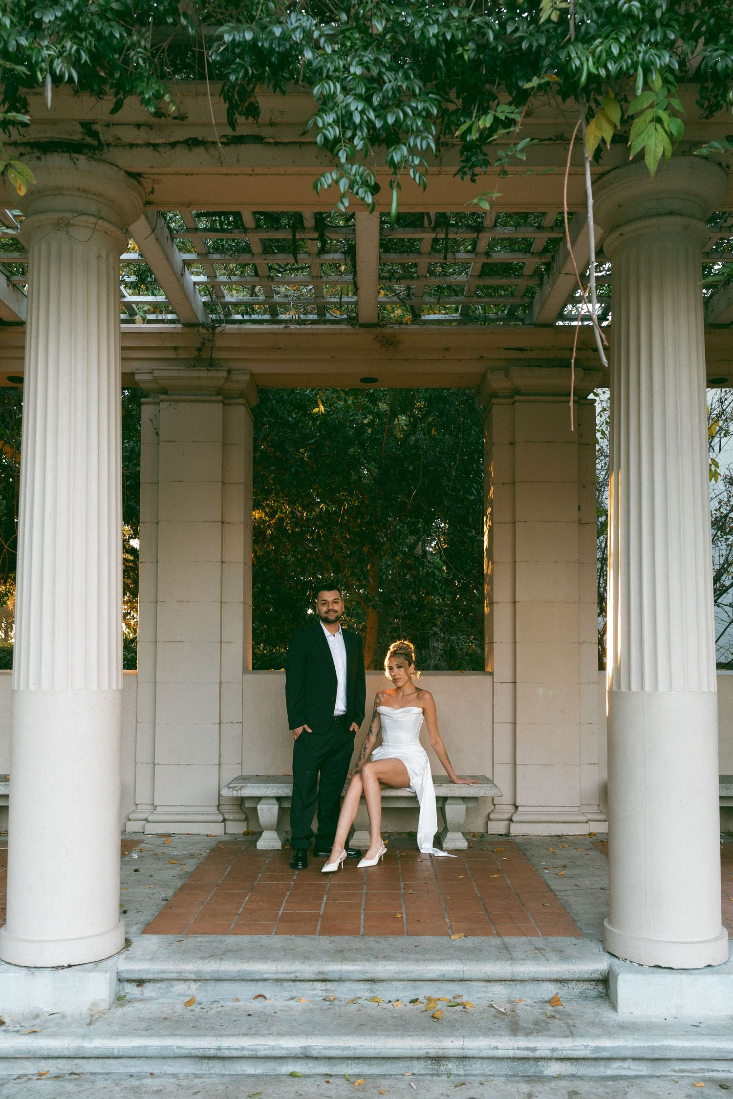 White columns frame a romantic wedding photoshoot in an outdoor courtyard.
