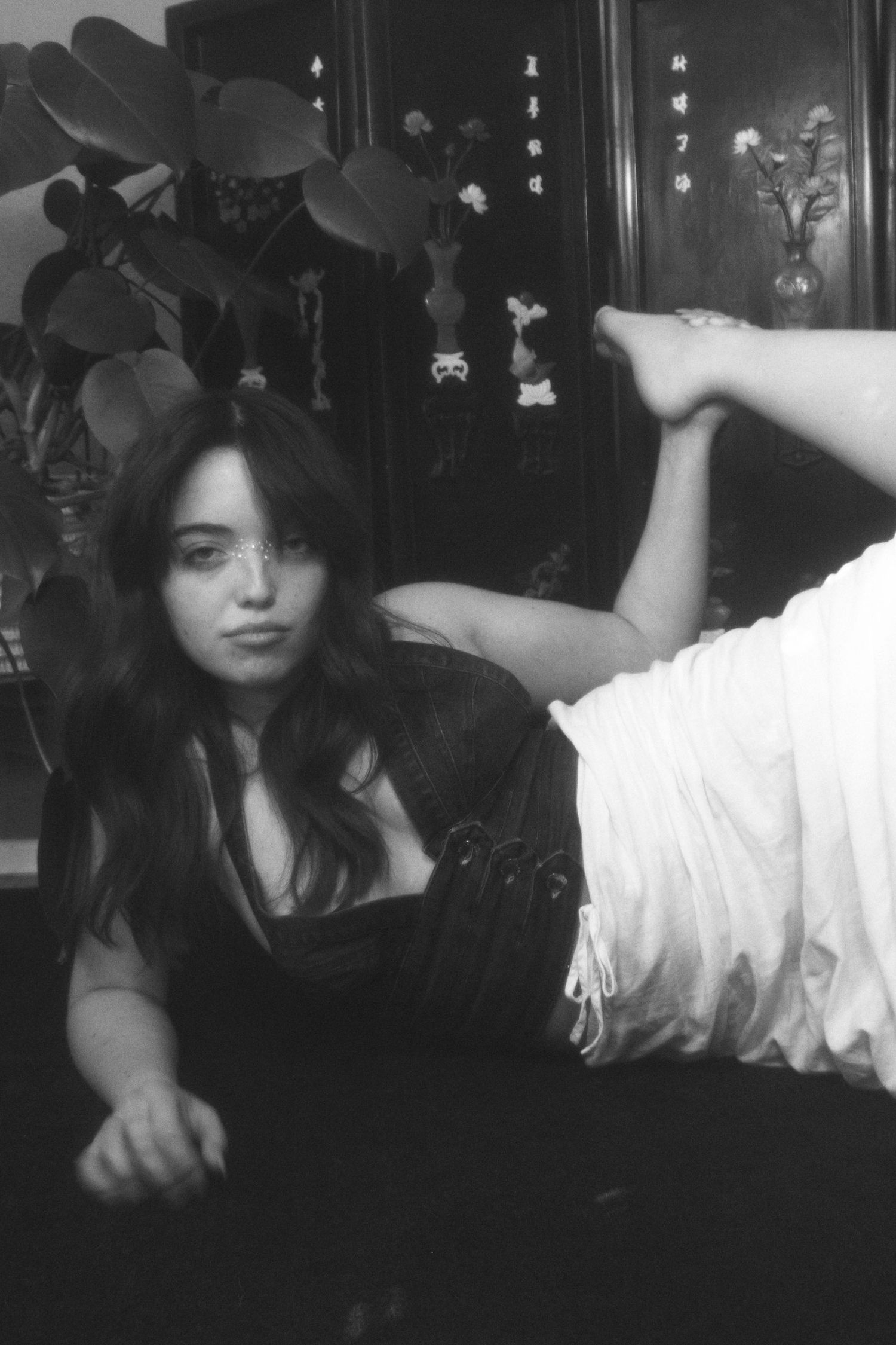 Black and white artistic portrait with dramatic lighting and vintage aesthetic.