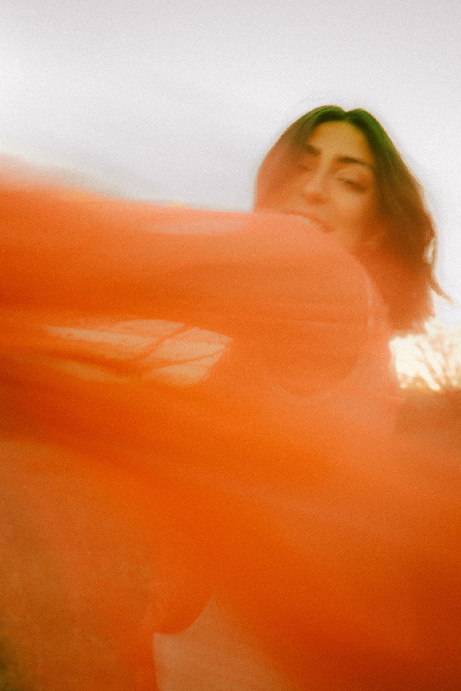 Abstract orange light leak photo creating dreamy atmospheric effect.