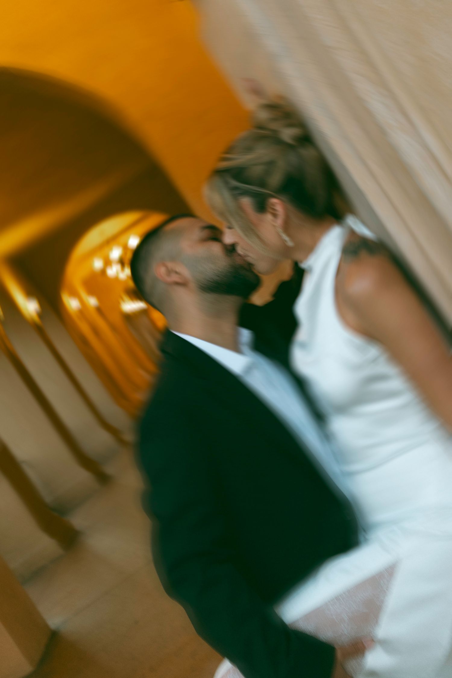 Couple dancing together in an elegant blur of motion at a wedding reception.