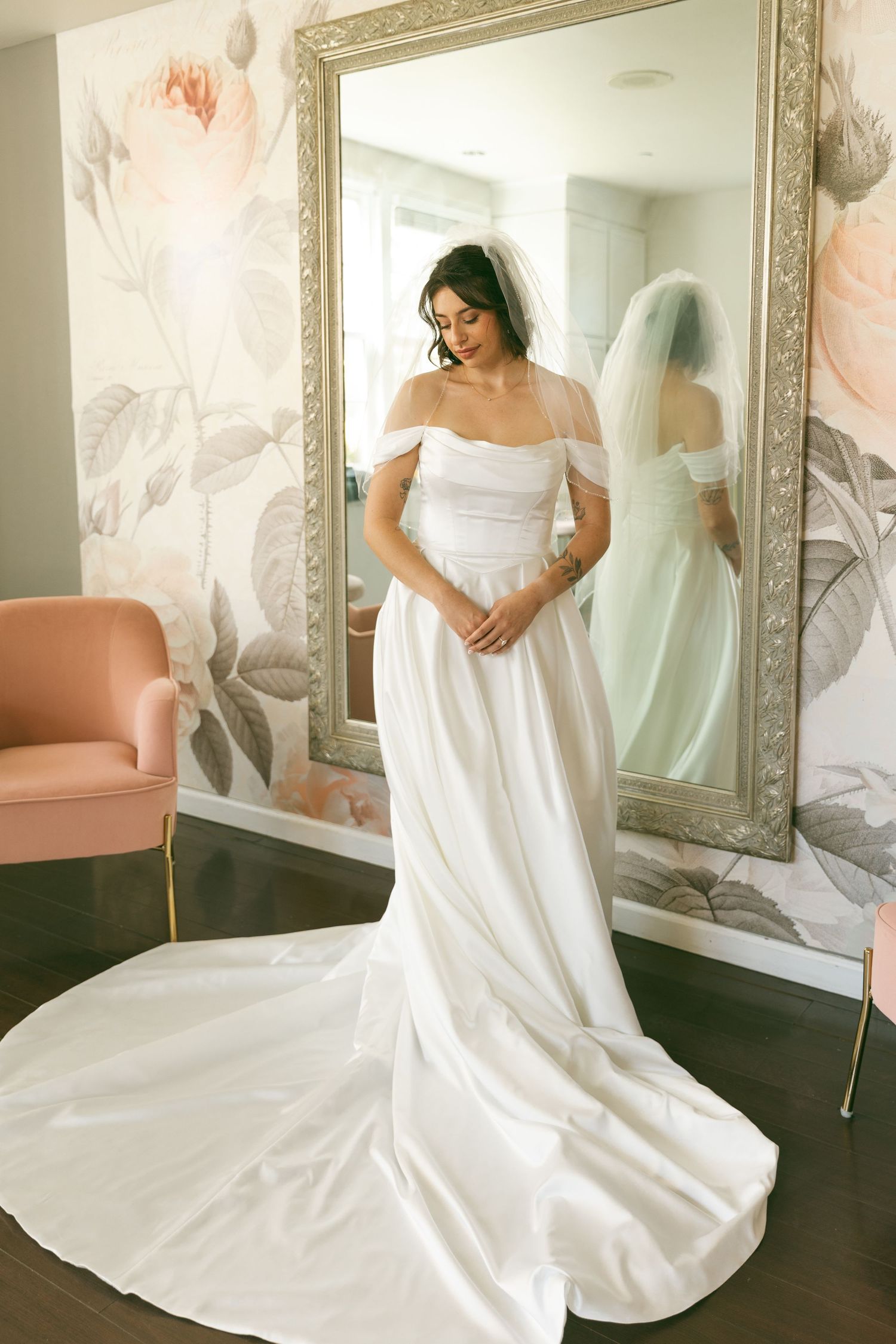 Artistic photo series of a bride in a classic white wedding gown posing near an ornate mirror.