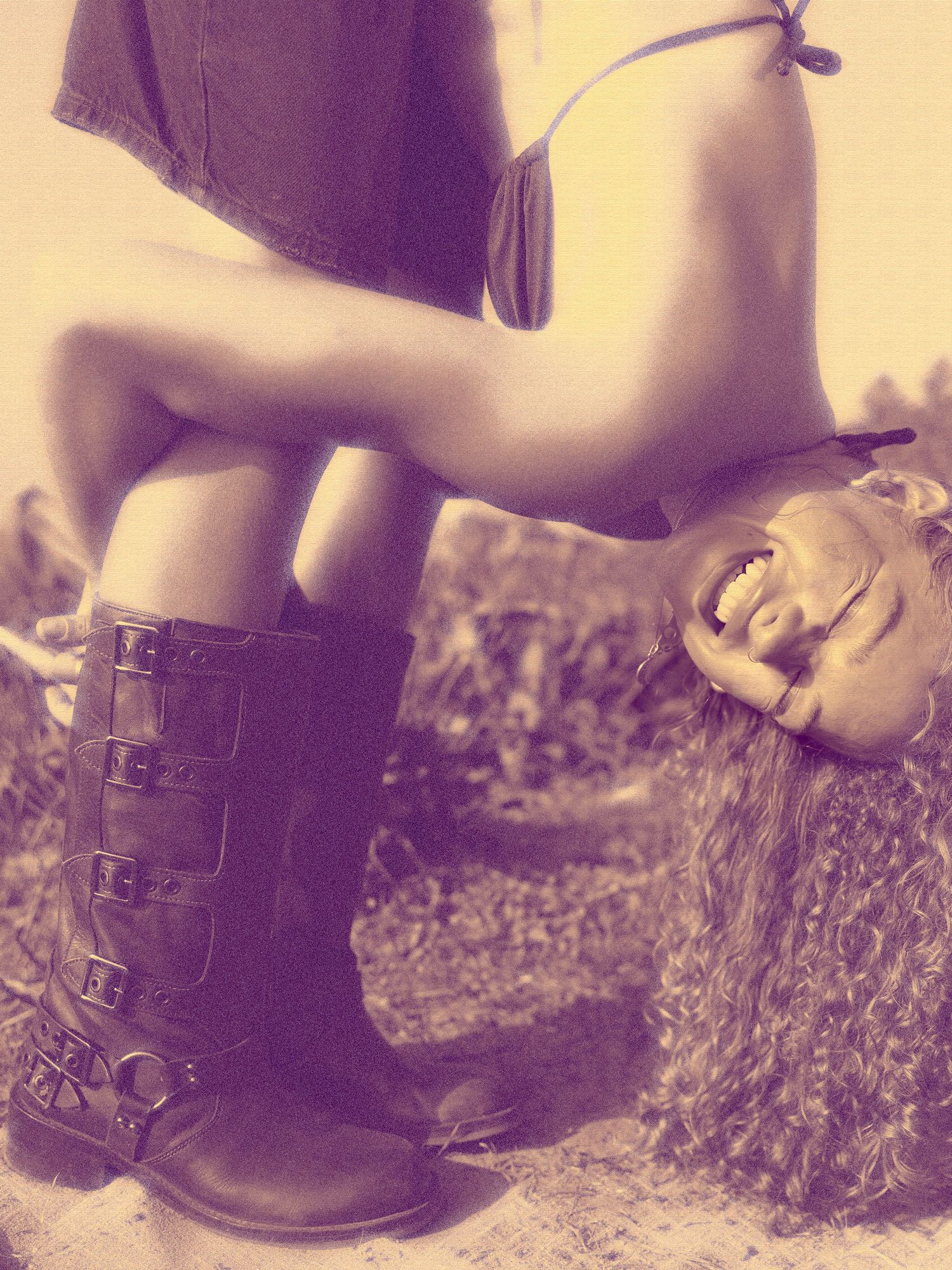 Vintage-style photo showing leather boots and carefree pose against natural backdrop.