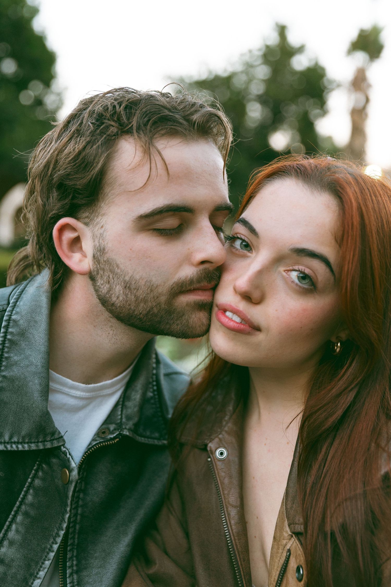 Intimate close-up moments shared against natural outdoor backdrop.
