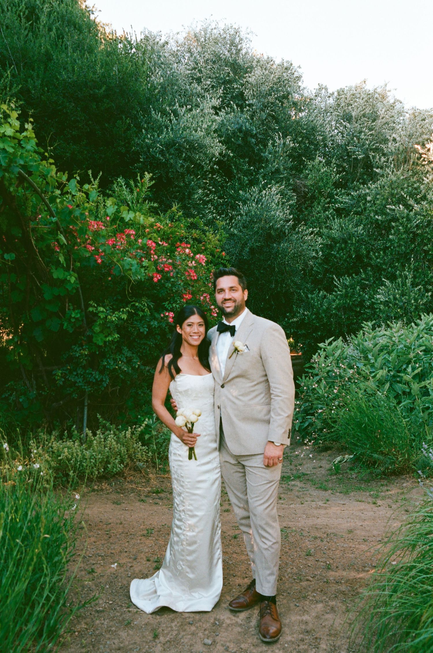 San Diego wedding photographer capturing a newlywed couple outdoors surrounded by lush greenery