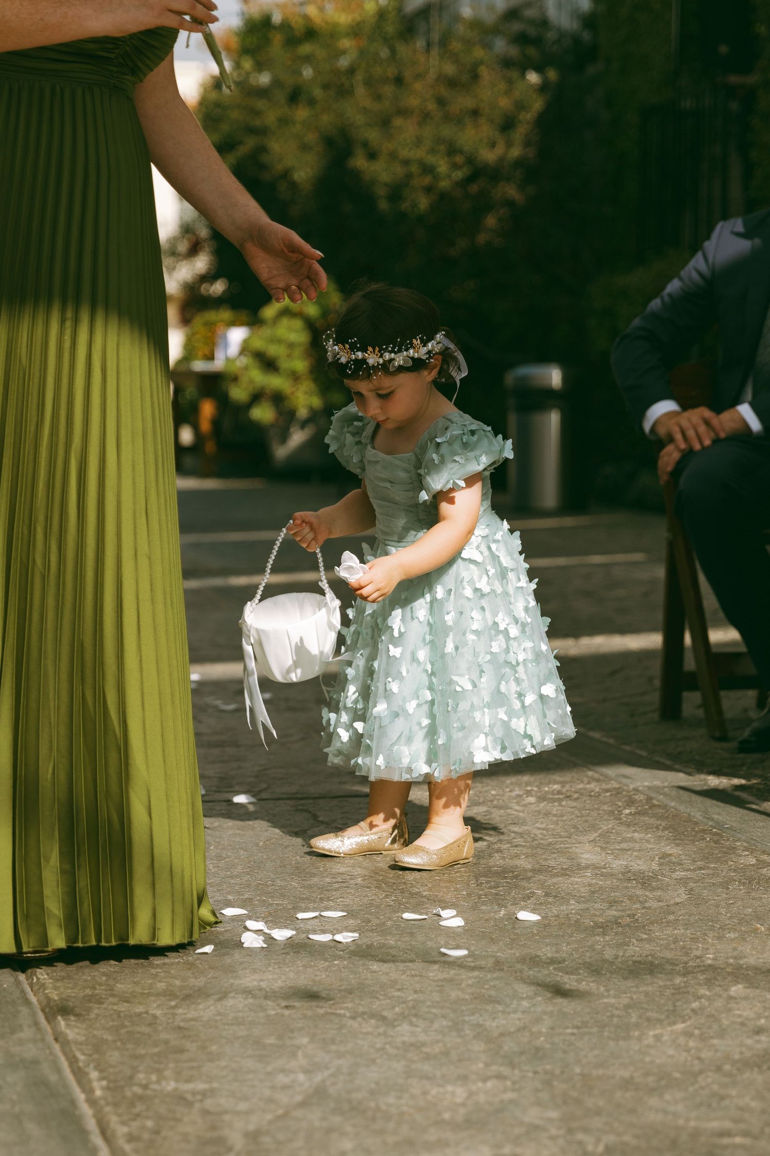 Close-up shots of a flowy mint green dress and white details during a formal event.