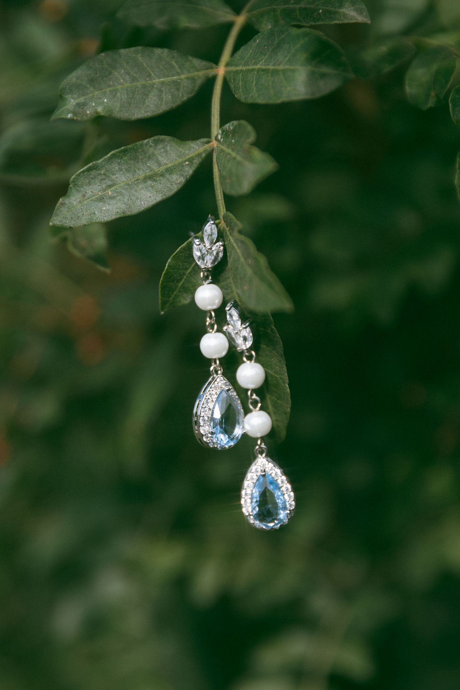 Bridal pearl and crystal earrings photographed outdoors, elegant wedding details from a Southern California wedding