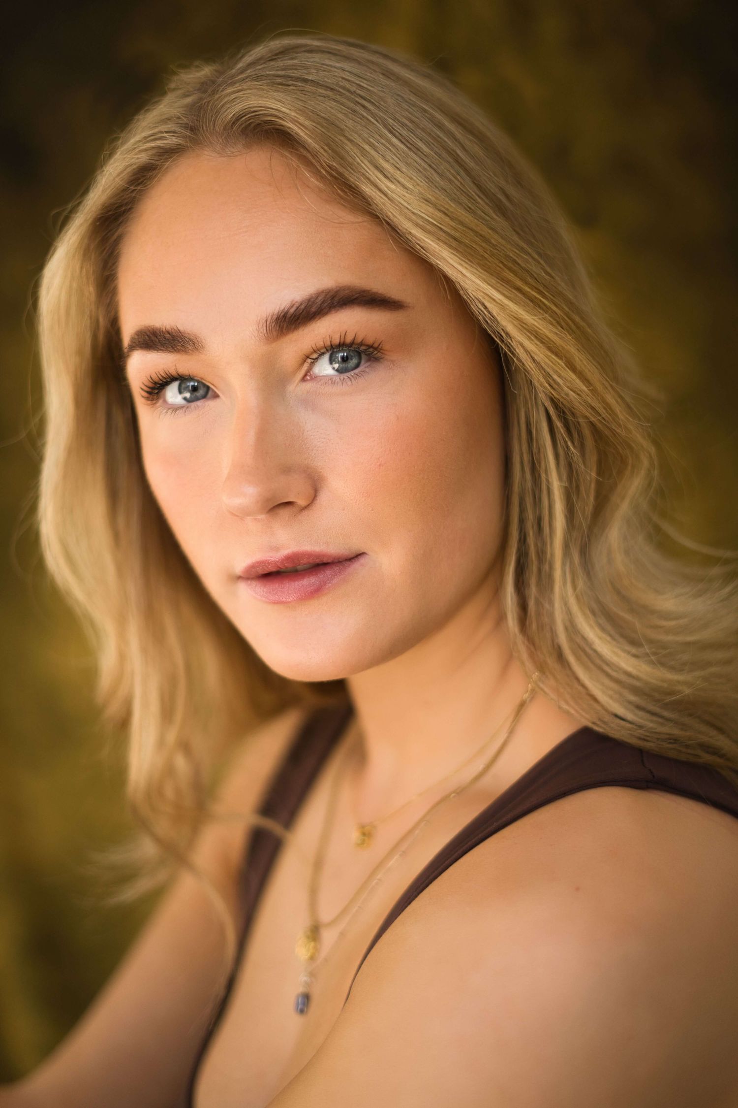 A series of portrait photographs showing close-up shots against a dark golden background.