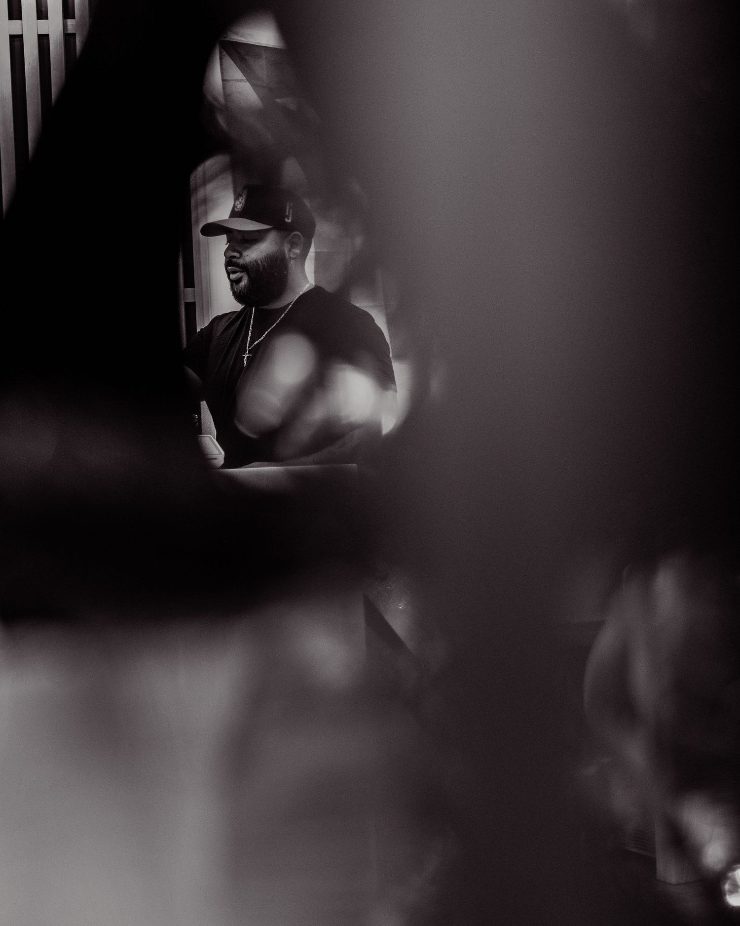 A series of dark, moody black and white portraits with dramatic lighting and shadows creating an artistic silhouette effect.