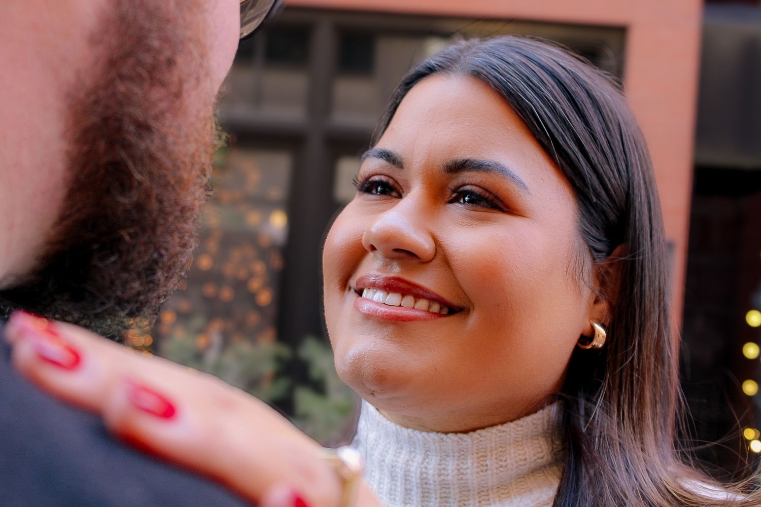 A close-up portrait showing genuine happiness during an engagement session.