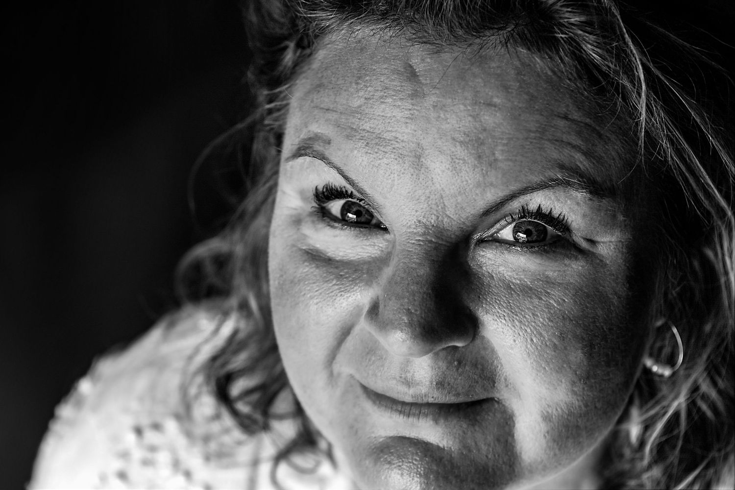 Dramatic close-up black and white portrait with intense eye contact.
