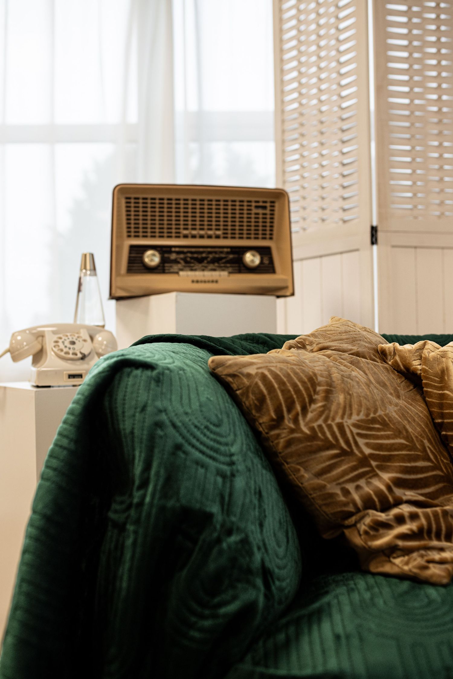 Een vintage radio met houten luiken, waarbij warm zonlicht door de lamellen naar binnen valt in daglichtstudio Zeewolde