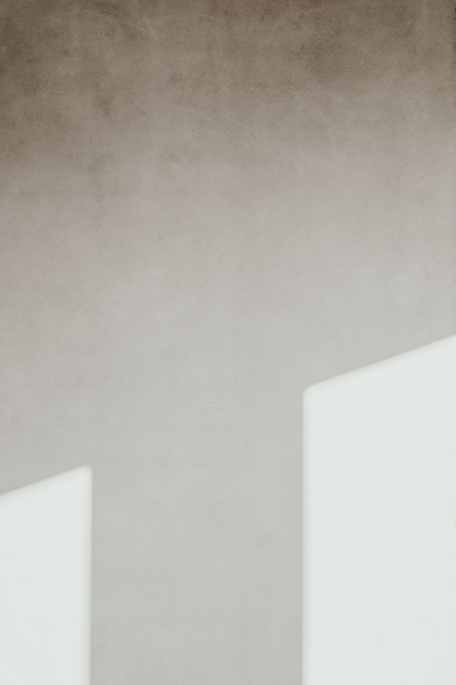 Light casting shadows on white wall