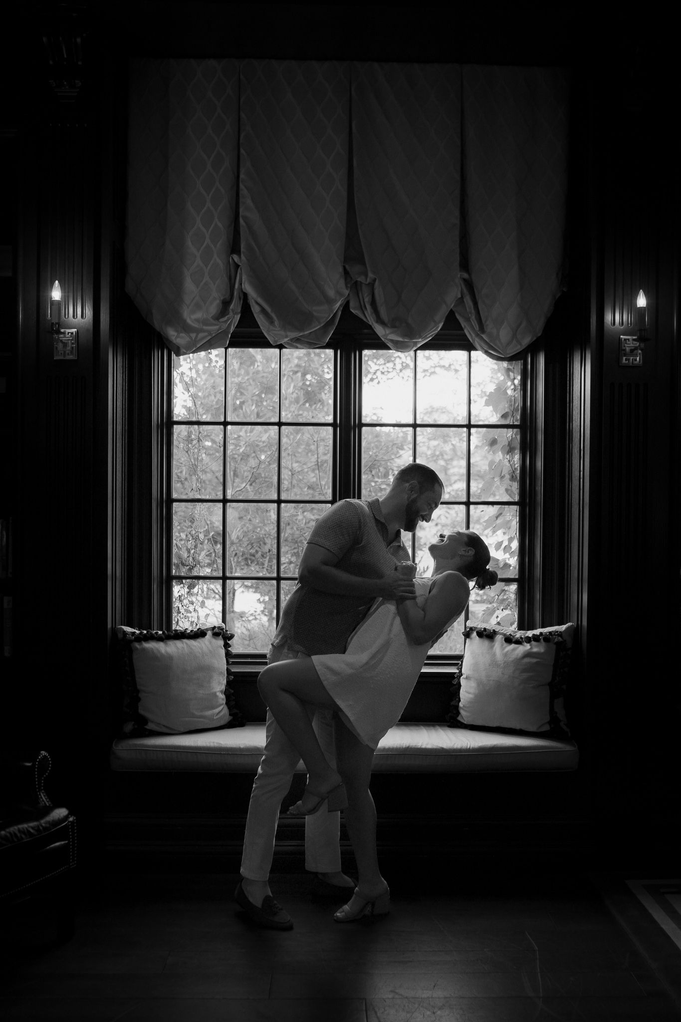 This photo was taken as the couple did a cute dip while they were dancing in the library. They are overlooking a window 