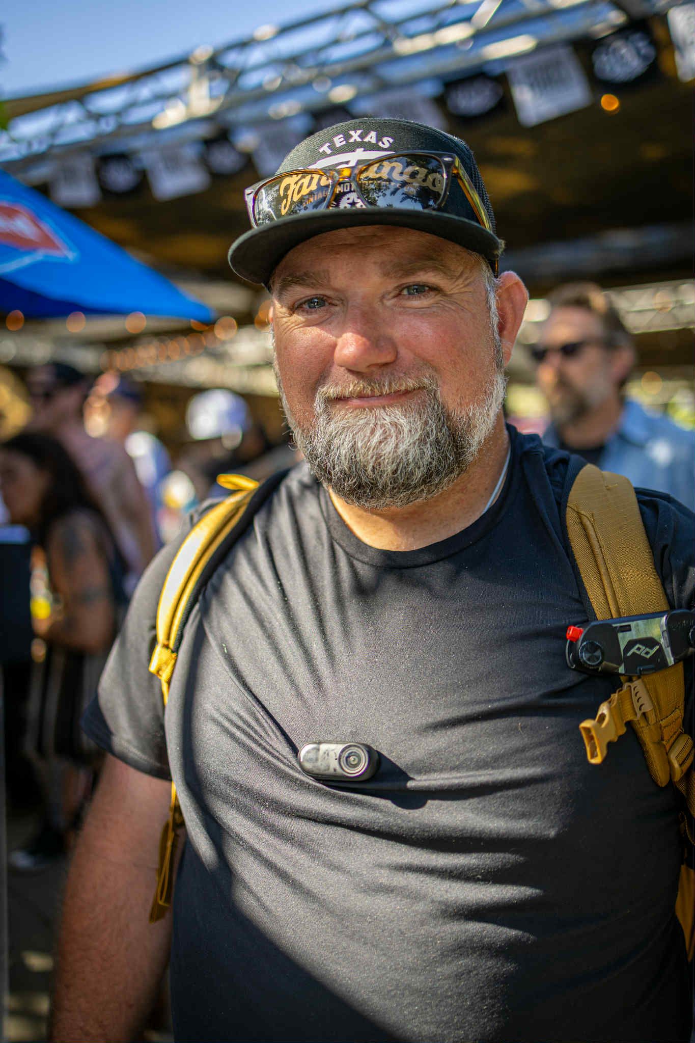 A series of candid closeup shots showing a person with a gray beard wearing a dark t-shirt and baseball cap at an outdoor event.